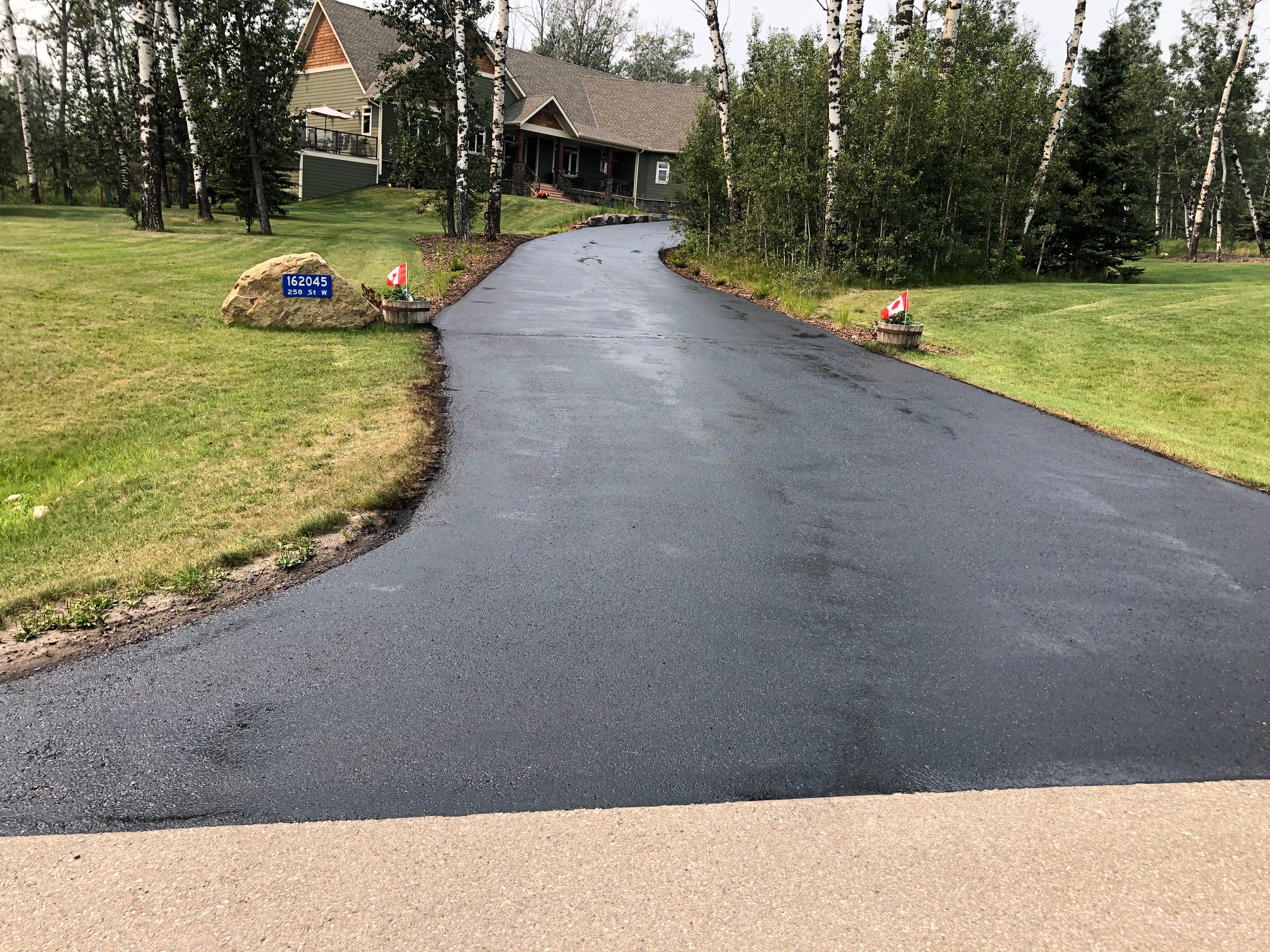 APC crew applying sealer to a prepared residential driveway